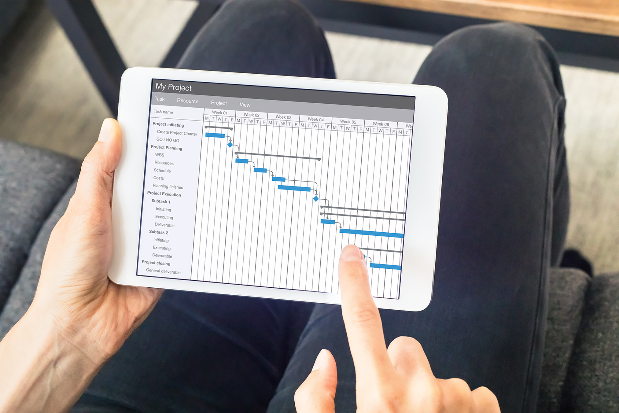 Project manager updating Gantt chart schedule, planning software